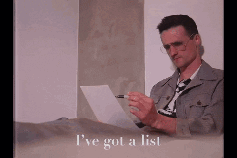 A Man Is Laying On A Bed Holding A Piece Of Paper With The Words I 'Ve Got A List Written Below Him GIF