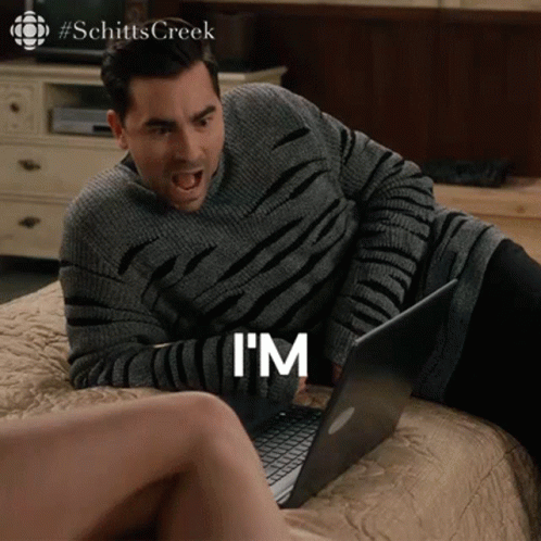 A Man Is Laying On A Bed Using A Laptop And Says I 'M GIF
