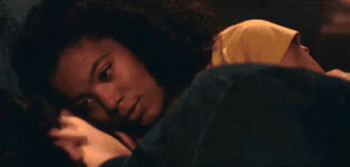 A Man Is Laying On A Bed With A Woman Holding His Arm GIF