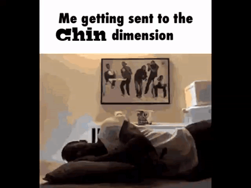 a man is laying on a bed with his head on a pillow and a picture on the wall behind him .