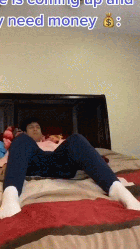 A Man Is Laying On A Bed With The Words " I Need Money " In The Corner GIF