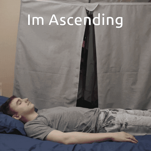 A Man Is Laying On A Bed With The Words Im Ascending Written Above Him GIF