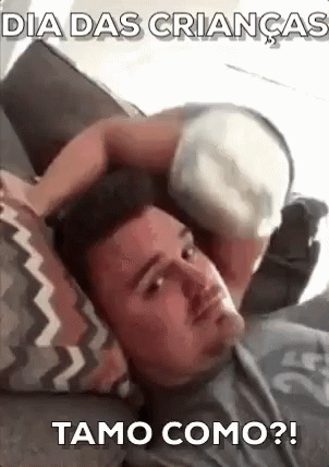 A Man Is Laying On A Couch With A Baby On Top Of His Head . GIF