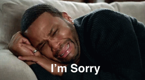 A Man Is Laying On A Couch With His Eyes Closed And The Words I 'M Sorry Written Below Him GIF