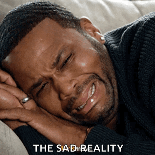 A Man Is Laying On A Couch With His Eyes Closed And The Words " The Sad Reality " Next To Him GIF
