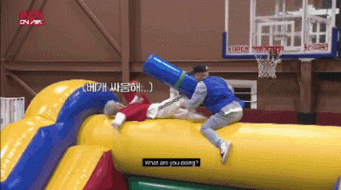 a man is laying on a large inflatable object and asking what he is doing