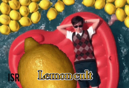 A Man Is Laying On A Red Raft Surrounded By Lemons And The Word Lemon Cult Is On The Bottom Right GIF