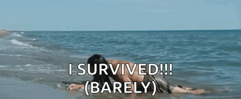 A Man Is Laying On The Beach With The Words `` I Survived !!! Barely '' Written Above Him . GIF