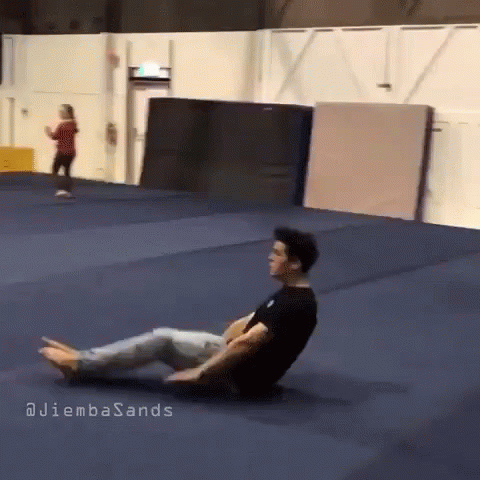 A Man Is Laying On The Floor In A Gym With The Words Juliembasands Written On The Bottom GIF