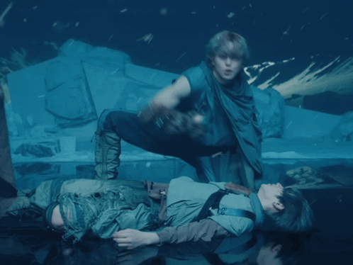A Man Is Laying On The Floor With Another Man GIF
