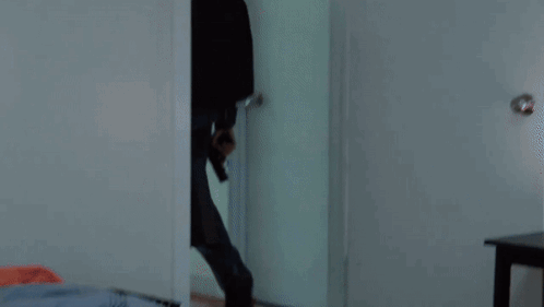 A Man Is Laying On The Floor With Blood On His T-Shirt GIF
