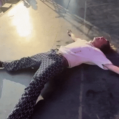 a man is laying on the floor with his arms outstretched