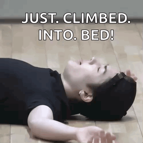A Man Is Laying On The Floor With The Words Just Climbed Into Bed Written Above Him GIF