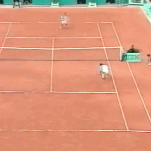 A Man Is Laying On The Ground On A Tennis Court GIF