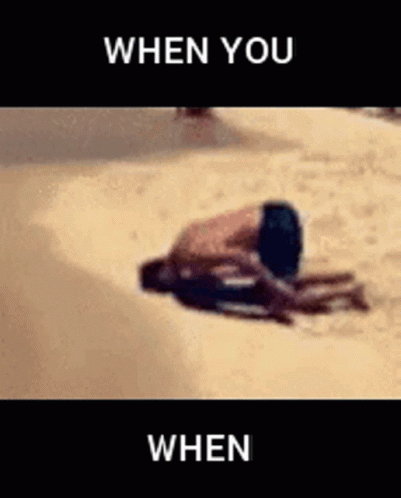 A Man Is Laying On The Ground On The Beach With The Words `` When You When '' Above Him . GIF