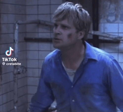 Man Lying On Ground With Chain Around Neck GIF