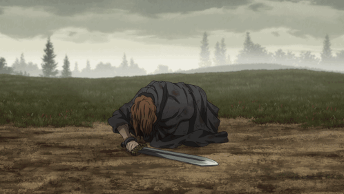A Man Is Laying On The Ground With A Sword In His Hand GIF
