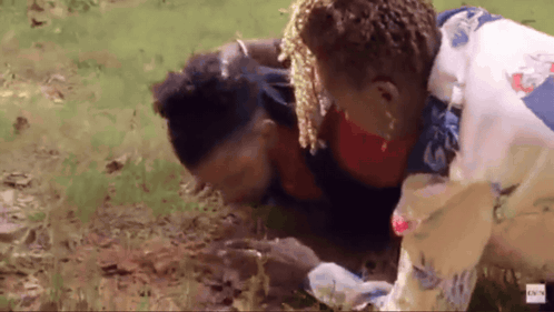 A Man Is Laying On The Ground With A Woman Standing Next To Him With A Bbc Logo In The Corner GIF