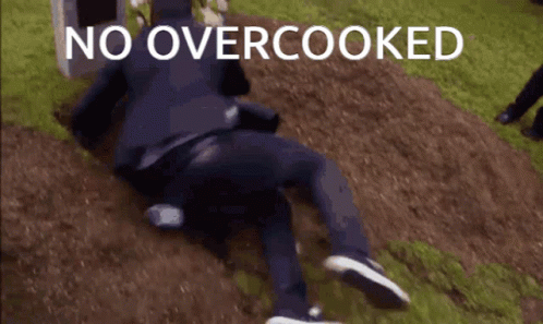 A Man Is Laying On The Ground With The Words No Overcooked Above Him GIF