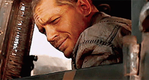 A Man Is Leaning His Head Out Of A Window And Smiling .. GIF