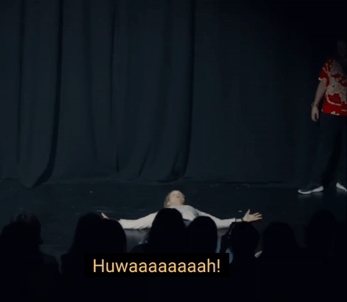 A Man Is Levitating In Front Of A Crowd With The Words Levitating Below Him GIF