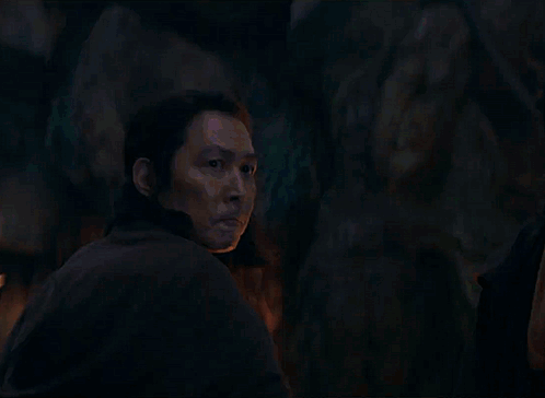 A Man Is Looking At A Blue Light Beam GIF