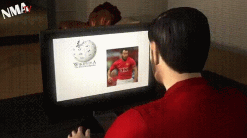 A Man Is Looking At A Computer Screen That Says Wikipedia GIF