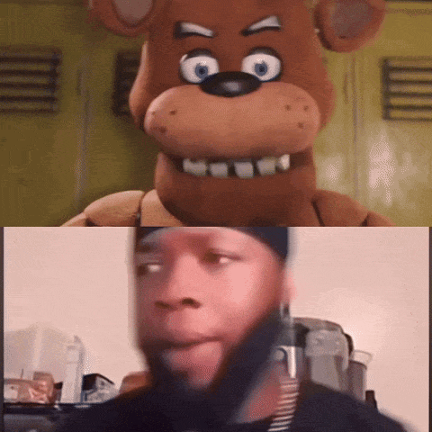 A Man Is Looking At A Teddy Bear While Another Man Looks On GIF