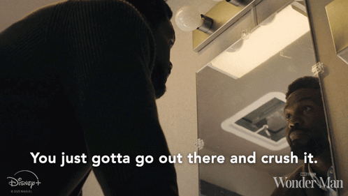 A Man Is Looking At Himself In A Mirror With The Words You Just Gotta Go Out There And Crush It GIF