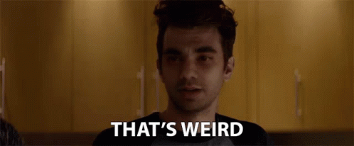 a man is looking at the camera with the words `` that 's weird '' behind him .