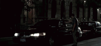 a man is looking out of a window with a blurry background of arrows