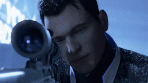 A Man Is Looking Through A Sniper Scope In A Dark Room GIF