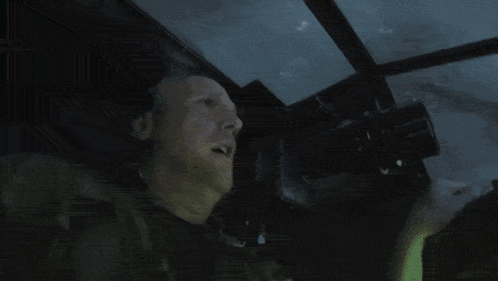 A Man Is Looking Through Binoculars With A Sign That Says ' Nikon ' On It GIF