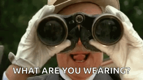 A Man Is Looking Through Binoculars With The Words `` What Are You Wearing ? '' Behind Him . GIF