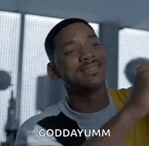 A Man Is Making A Funny Face And Saying `` Goddayumm '' While Standing In Front Of A Window . GIF
