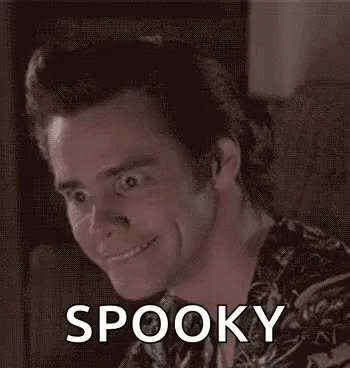 A Man Is Making A Funny Face And Smiling While Sitting On A Couch With The Word Spooky On His Face . GIF
