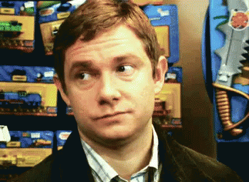 A Man Is Making A Funny Face In Front Of A Display Of Toy Guns GIF