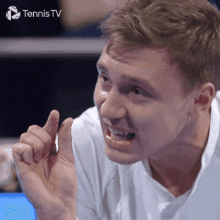 A Man Is Making A Funny Face In Front Of A Tennis Tv Sign GIF