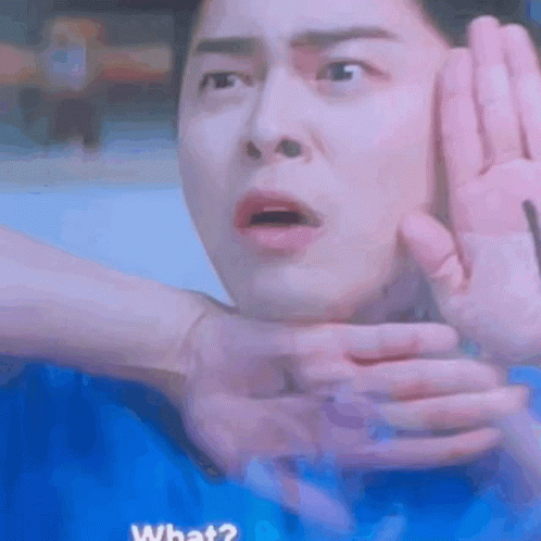 A Man Is Making A Funny Face While Being Held By Someone 'S Hands . GIF