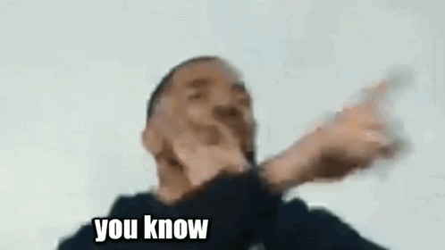A Man Is Making A Funny Face While Holding A Glass Of Water . GIF