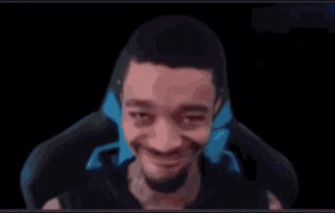 A Man Is Making A Funny Face While Sitting In A Chair In Front Of A Black Background . GIF