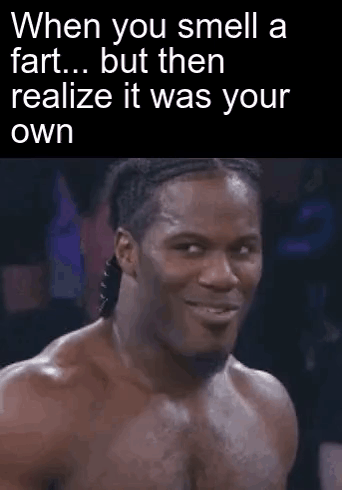 A Man Is Making A Funny Face While Smelling A Fart . GIF