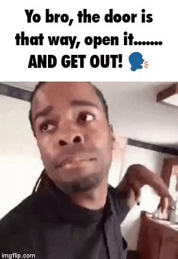 A Man Is Making A Funny Face While Standing In Front Of A Door . GIF