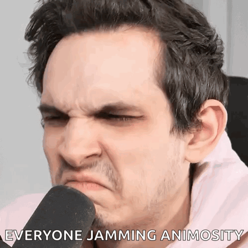 A Man Is Making A Funny Face While Talking Into A Microphone With The Words " Everyone Jamming Animosity " Written Below GIF