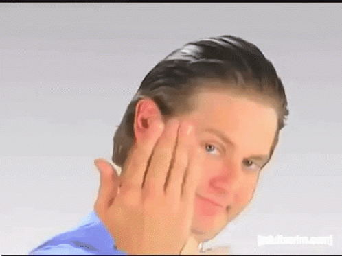 A Man Is Making A Funny Face While Touching His Face With His Hands . GIF