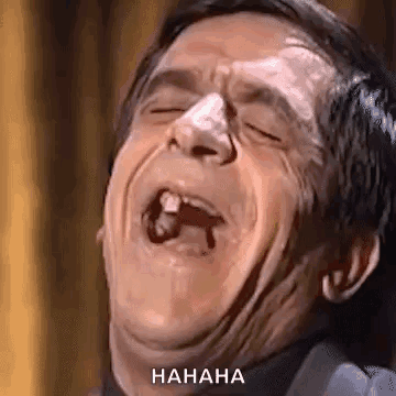 A Man Is Making A Funny Face With His Mouth Open And A Tooth Missing . GIF