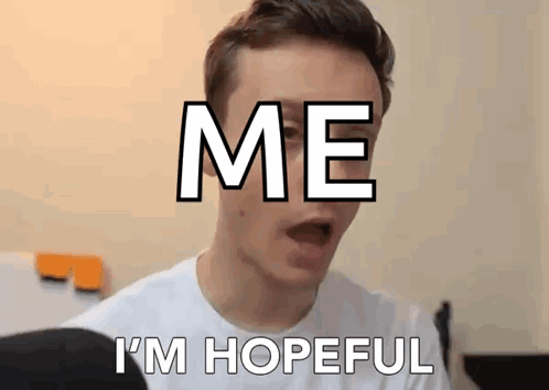 A Man Is Making A Funny Face With The Words `` Me I 'M Hopeful '' Written On His Face . GIF