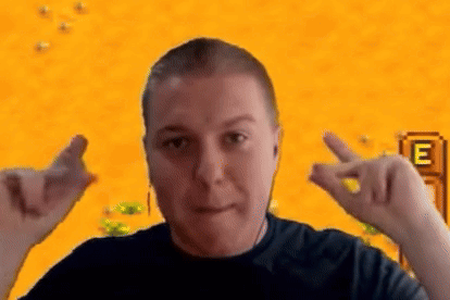 A Man Is Making A Heart Shape With His Hands In Front Of A Video Game Screen . GIF