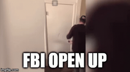 A Man Is Opening A Door With The Words Fbi Open Up Written On It GIF