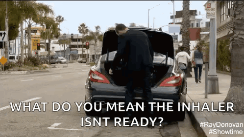 A Man Is Opening The Trunk Of A Car And Says What Do You Mean The Inhaler Isnt Ready . GIF